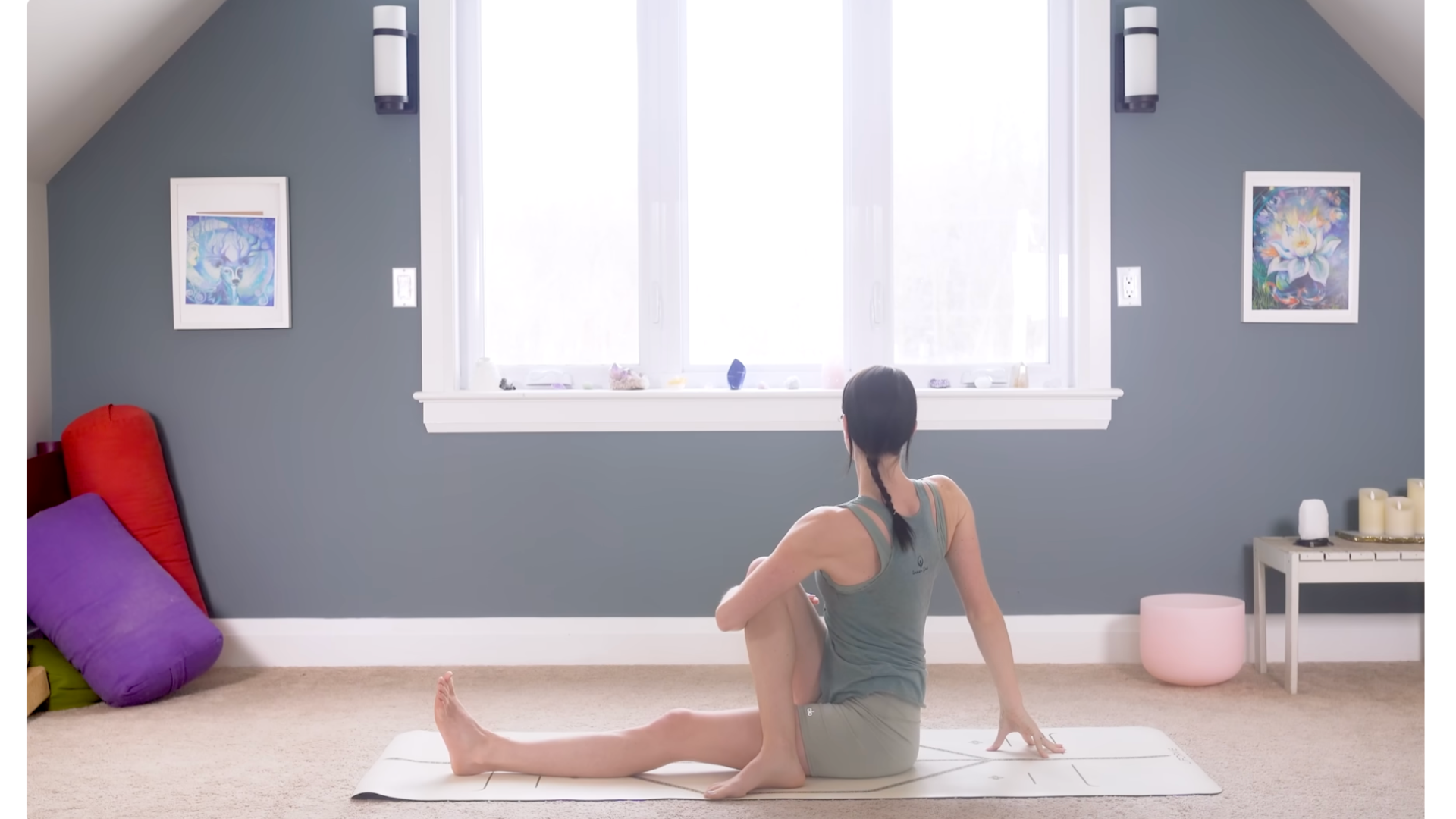 Woman sitting on a mat twisting to the right